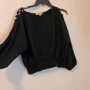 Small, black, shoulder detail top.
